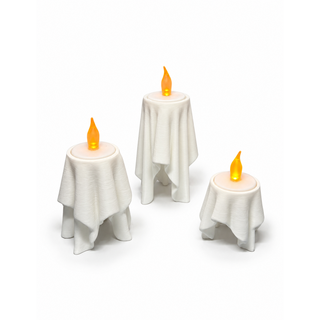 Floating Drape LED tealight holders in three sizes, lit on white background