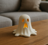 White melting ghost LED tealight decoration on a wooden table